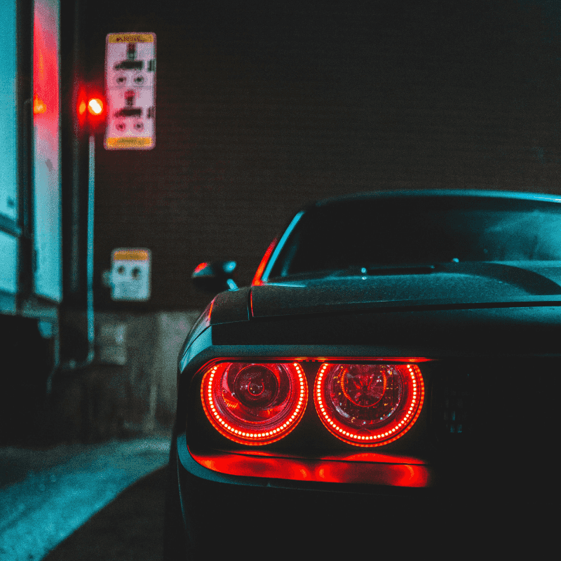 Car at night with brake lights on at stop light.